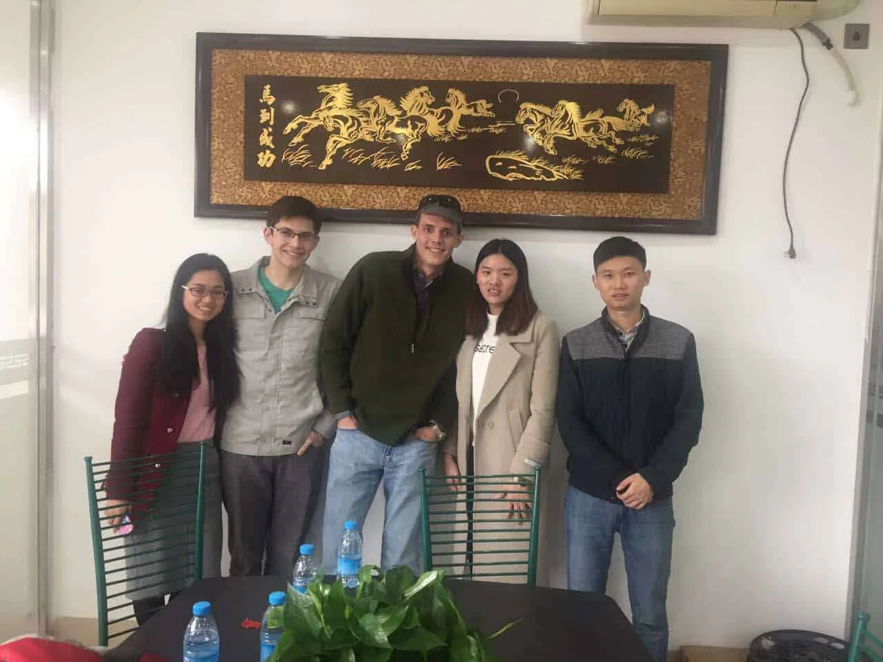 English-Chinese interpreter with overseas clients and a Chinese supplier after a factory meeting