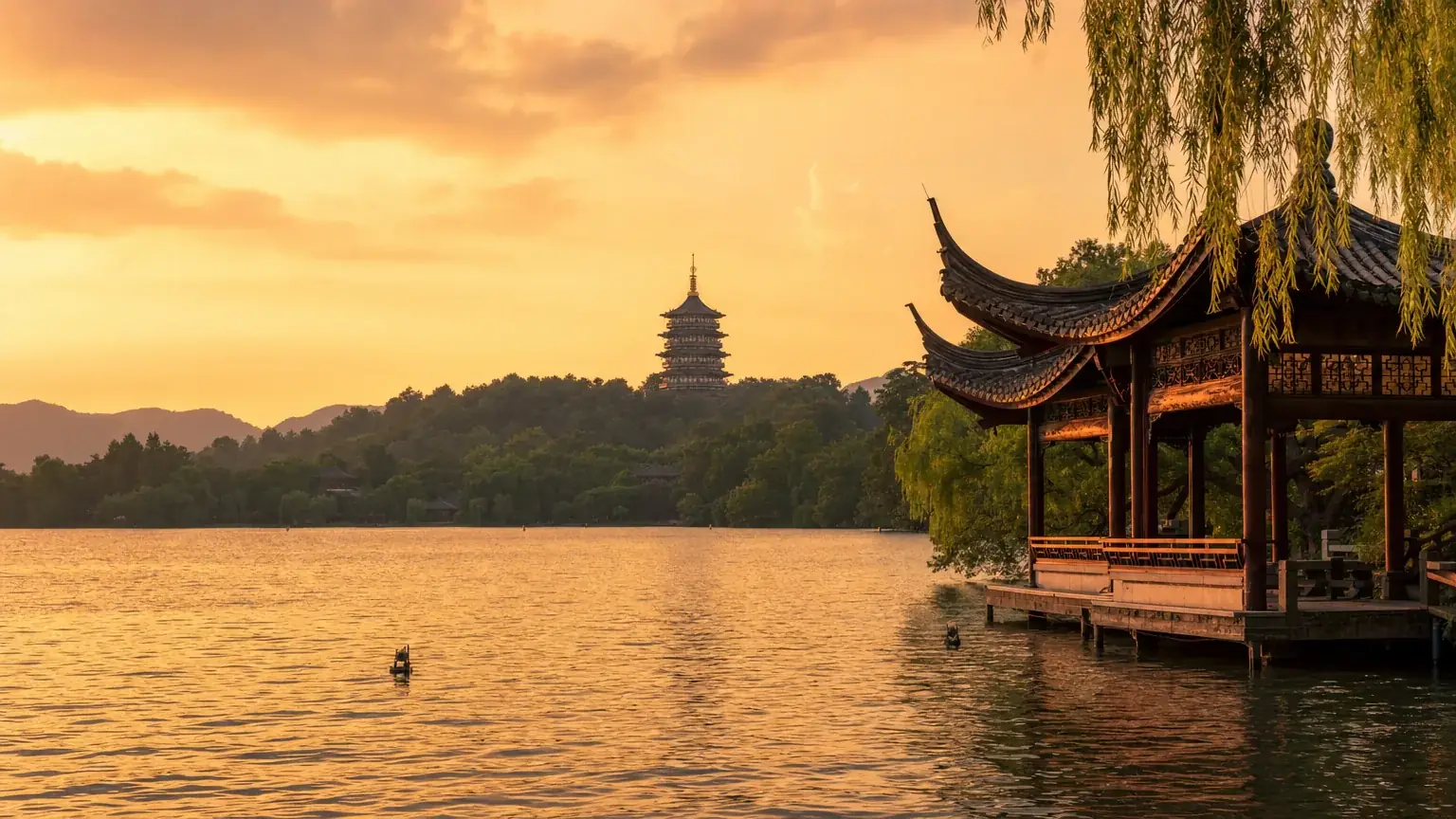 West Lake in Hangzhou with the Leifeng Pagoda and a lakeside pavilion at golden hour